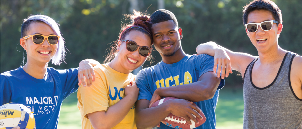 Group of friends at UCLA holding a volleyball and football